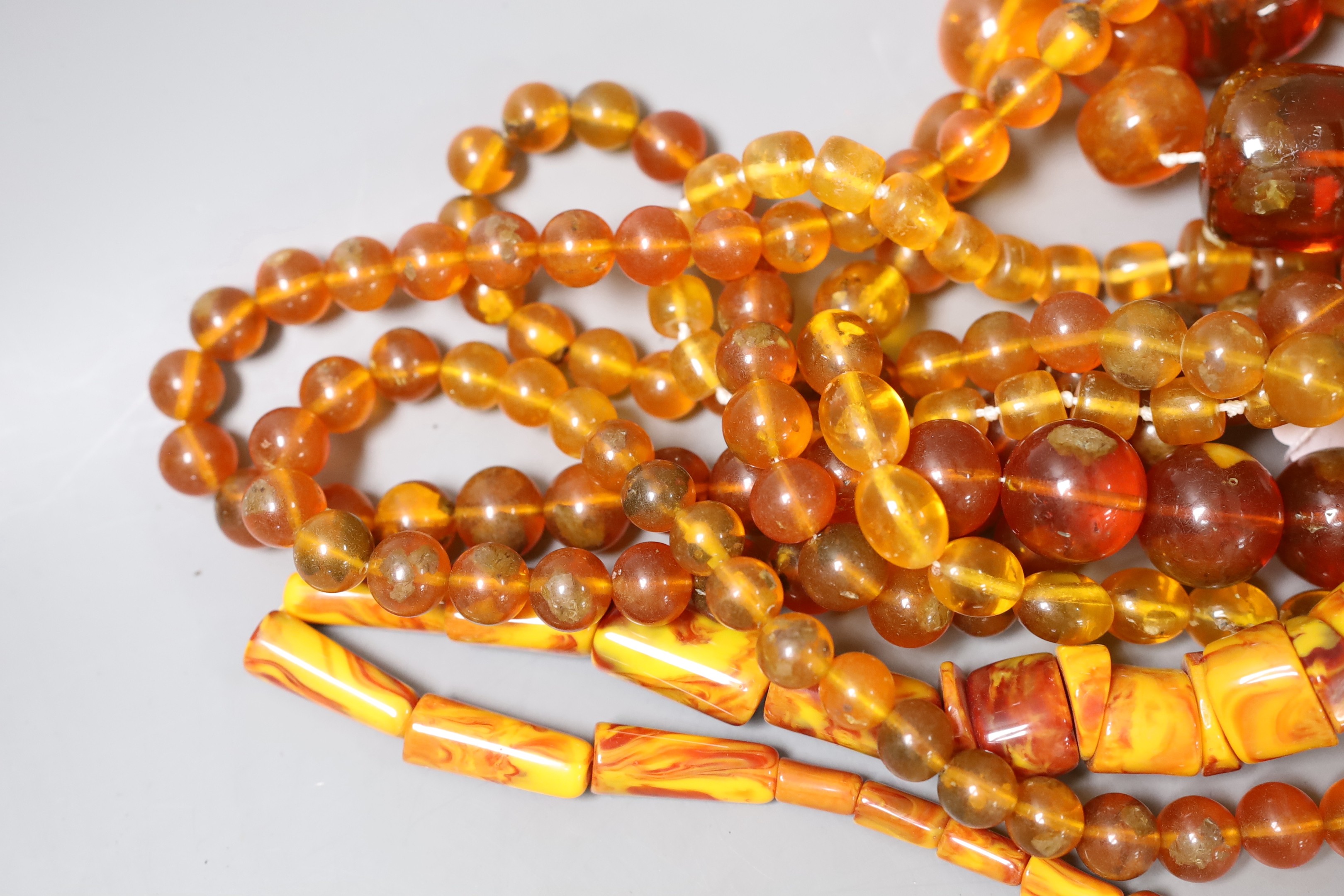 A group of amber and simulated amber bead necklaces (6).